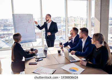 The boss stands near the board with graphs, demonstrates statistics, various personnel attending the training, introduces the new products of the company, reports on the results of work for partners. - Powered by Shutterstock