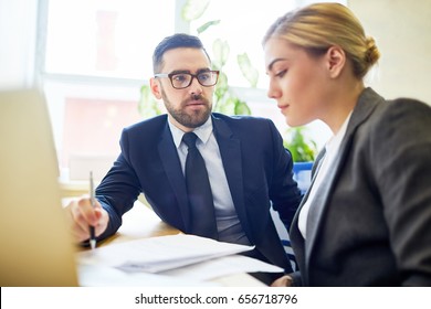 Boss Talking To One Of Employees At Meeting