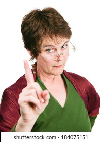 Bossy looking middle-aged woman wagging her finger in disapproval.  Isolated on white.  