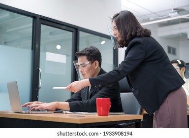 Bossy Manager Female Ordering And Pointing At Laptop Of Office Male Worker Wearing Face Shield At New Normal Office