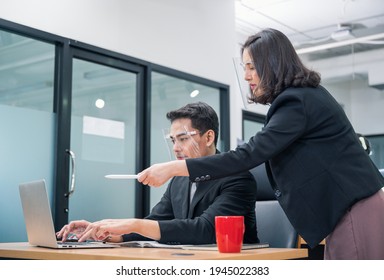 Bossy Manager Female Ordering And Pointing At Laptop Of Office Male Worker Wearing Face Shield At New Normal Office