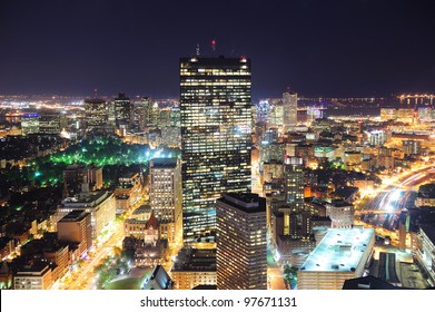 Boston aerial view with skyscrapers at night with city skyline illuminated.