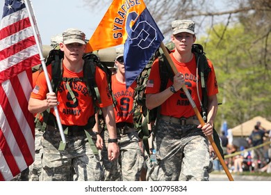 BOSTON - APRIL 16 : Fans cheer on Syracuse ROTC marching the boston marathon in full 40 lb ruck-sacks during the Boston Marathon April 16, 2012 in Boston.