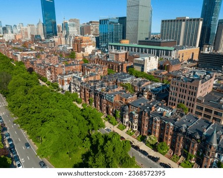 Boston Back Bay historic townhouses on Commonwealth Avenue with modern city skyline at the background, Boston, Massachusetts MA, USA. 