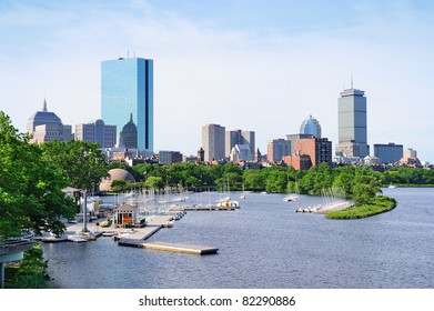 Boston Back Bay With Sailing Boat And Urban Building City Skyline In The Morning.