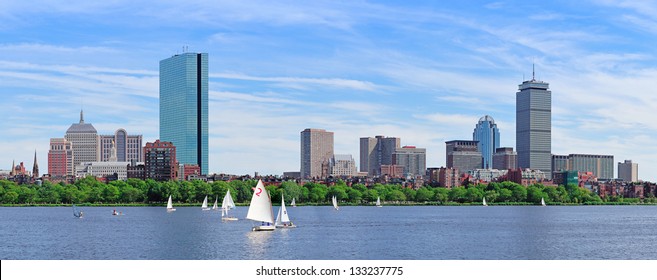 Boston Charles River panorama with urban city skyline skyscrapers and boats with blue sky.