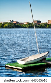 Boston Charles River sailboat in the foreground and historic Beacon Hill skyline across the water. Copy space.