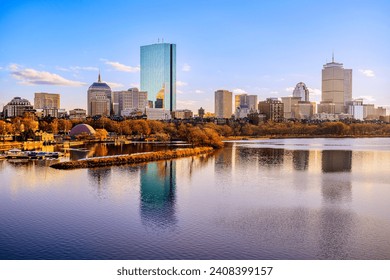 Boston City Skyline over the Charles River in Massachusetts, USA. A tranquil riverscape of Back Bay with golden illuminated wintery foliage in New England. - Powered by Shutterstock