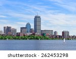 Boston city skyline with Prudential Tower and urban skyscrapers over Charles River with boat.