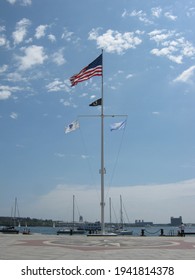 Boston Harbor with American flag and Massachusetts flag on display on the flagpole