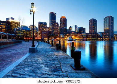 Boston Harbor and Financial District in Boston, Massachusetts in the sunset. - Powered by Shutterstock