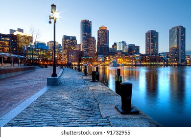 Boston Harbor and Financial District at sunset in Boston, Massachusetts.