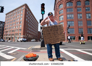 BOSTON -JUNE 05: Vietnam War veteran salutes passers-by as he beggs for money on the streets of Boston on June 05, 2012 in Boston, MA
