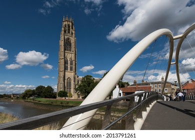 Boston, Lincolnshire, England - August 27 2015: St Botolph's church tower and footbridge over the River Witham
