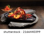 Boston Lobster tossed with Salted Egg Yolk served in a dish side view on wooden background