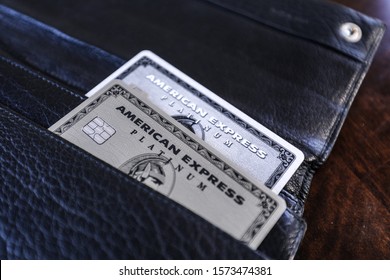 Boston, MA 11/28/2019 — The Old Plastic American Express Platinum Card And The New Stainless Steel Metal Version In A Black Leather Prada Wallet.