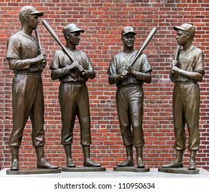 BOSTON, MA - AUGUST 10: The Landmark Statues Of Ted Williams, Bobby Doerr, Johnny Pesky, And Dom Dimaggio Attract Hundreds Of Baseball Fans To The Fenway Park In Boston, MA For Souvenir Photos On August 10, 2012.