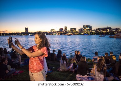 BOSTON, MA, July 3, 2017: Beautiful Woman Takes A Selfie In Front Of Boston Harbor, At Esplanade Park, Before The Annual Boston Pops July 4th Practice Concert. 