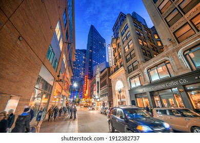 BOSTON, MA - OCTOBER 2015: Night view of city streets with tourists and locals.