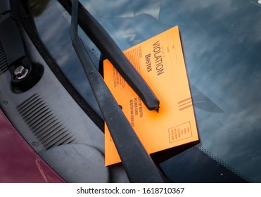 Boston, MA - September 23, 2019: Vehicle receives parking violation in the city of Boston on windshield of car. The ticket fine is payable to the City of Boston.
