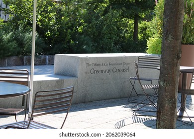 Boston, MA, USA, 9.11.21 - The sign engraved into a granite wall surrounded by outdoor tables and chairs. It reads "The Tiffany and Co. Foundation Grove at the Greenway Carousel".