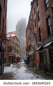 Boston, MA, USA - Dec 17, 2016: People Out Walking Down The Street. Snowstorm In Boston