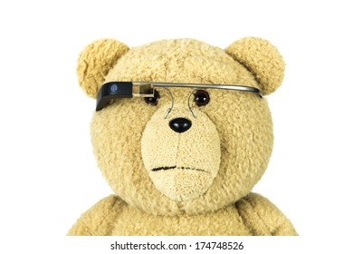 BOSTON, MA, USA - JANUARY 31, 2014: A photo of a bear doll wearing Google Glass. Google Glass is a wearable computer with an optical head-mounted display that is being developed by Google
