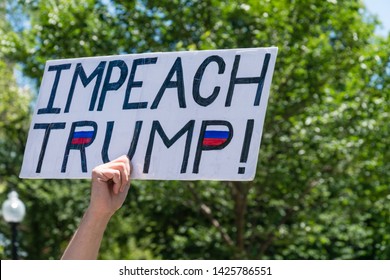 Boston, MA / USA - June 15, 2019: Crowd of citizens protest to impeach President Donald Trump at rally held in front of the state capital building in Boston.