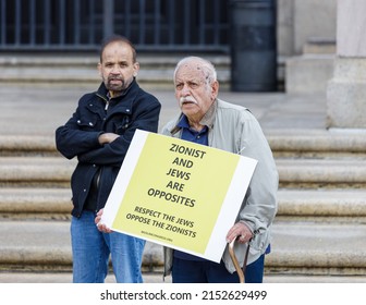 Boston, Massachusetts (United States Of America). April 29, 2022. Peace Activists And Palestinian Supporters Protest Against The Israeli Occupation Of Palestine. An Old Man Is Holding A Yellow Sign