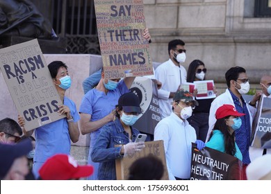 Boston, Massachusetts (USA)- June 14, 2020. The Association Of The Pakistanis Physician Met At The Boston Public Library To Request Justice For George Floyd. Two Nurses In Blue Are Caring Signs