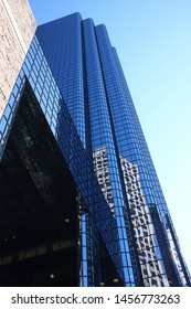 Boston, Massachusetts / U.S.A - Oktober 20 2014: Abstract Of The Exchange Place Boston Sky Scraper Before Light Blue Sky And Reflection Of Other Buildings