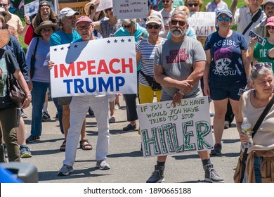 Boston, Massachusetts, US-June 15, 2019: Protesters hold signs reading "Impeach Trump"