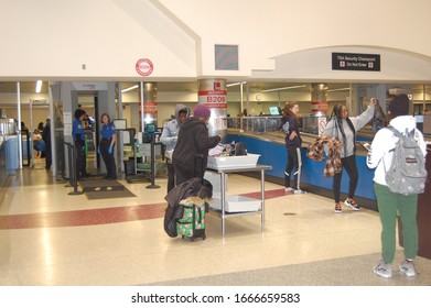 Boston, Massachusetts/United States Of America - February 27, 2020: TSA Security Screeners At Boston Logan Airport Wear Blue Gloves As A Healthy Safety Precaution To Prevent COVID 19 Novel Coronavirus