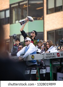 BOSTON, UNITED STATES; FEBRUARY 5 2019: Tom Brady in a duck boat shares the Super Bowl trophy with the city of Boston during the parade after winning the competition.