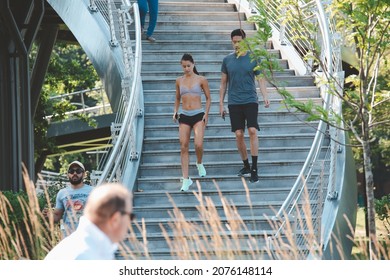 BOSTON, USA - JULY 14, 2021 : People ride jogging Crossing overpass to Charles River esplanade in the summer at Boston, USA.