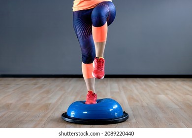 BOSU Ball Balance Training Ball Workout. Young Woman Doing BOSU Ball Exercises