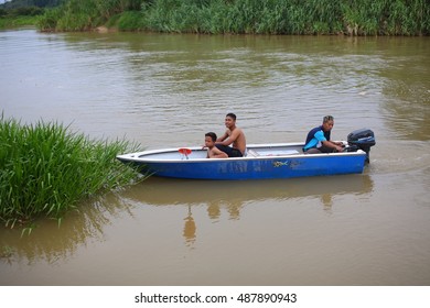 BOTA, MALAYSIA - SEPTEMBER 12, 2016: Two Malay Children Accompanied By Their Uncle To Sightseeing With Boat On The River Of Perak