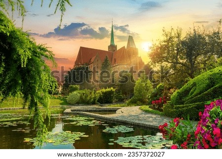 Botanical garden of Wroclaw. View of the cathedral and the lake with lotuses