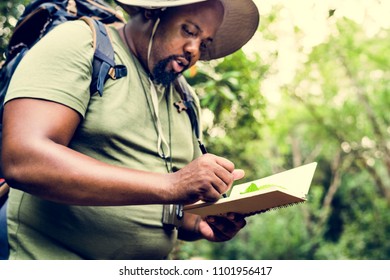 Botanist making notes in his notepad