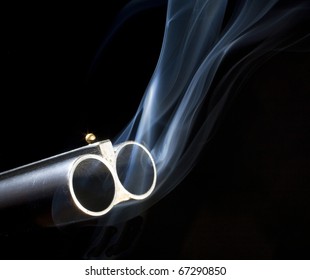 Both barrels on a double barrel shotgun with smoke
