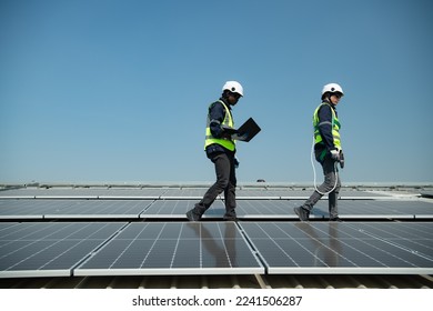 Both of Engineer in charge of solar panel installation The installation of solar energy conversion into electricity for a warehouse is currently being investigated.