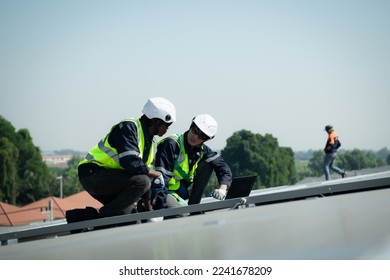 Both of Engineer in charge of solar panel installation The installation of solar energy conversion into electricity for a warehouse is currently being investigated.
