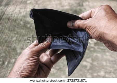 Both hands open an empty wallet, asian man hands,  economic difficulties, poverty, economical crisis. increasing poverty rates. blur background. 