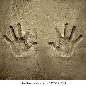 both hands print on cement mortar wall with shadow relief