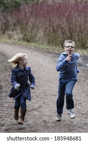 Bother And Sister Running  In Woods 