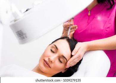 Botox Hair Close-up, A Doctor Injects A Botox Injection Into The Hair Of A Young Patient