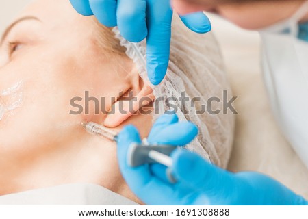 Botox injection in the face in the jaw area - aesthetic medicine - Botulinum toxin type A - youth injections