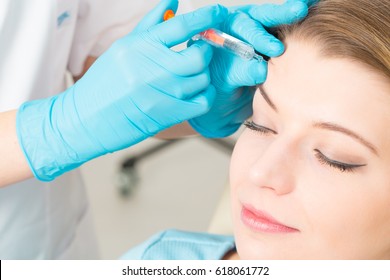 botox woman facial young syringe injecting skin