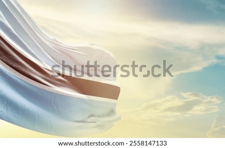 Botswana flag wave in soft clouds Country flag beautifully waving in the sky. Botswana national flag for independence day.