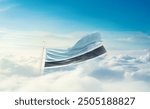 Botswana national flag hidden in the sky. The flag with drone shot in beautiful clouds. Botswana national flag for independence day.